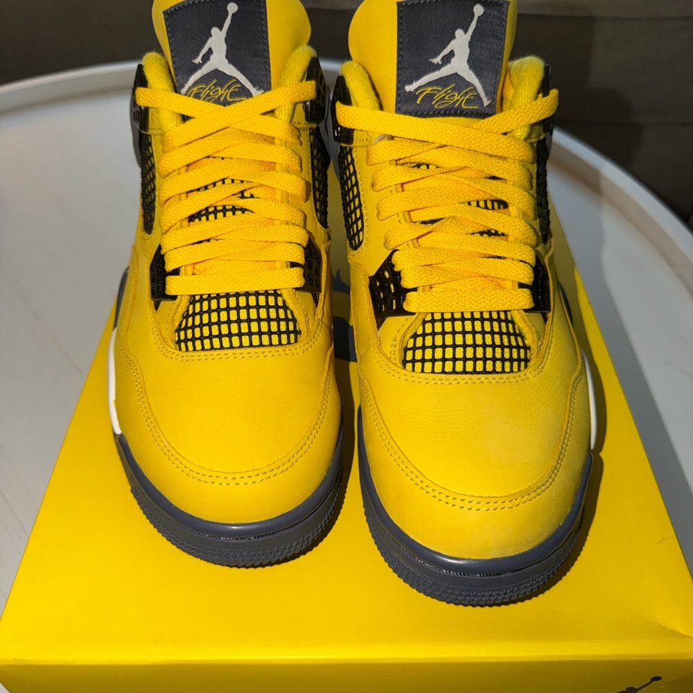 Air Jordan 4 Retro “Lightning” in Tour Yellow/Dark Blue Grey colorway.